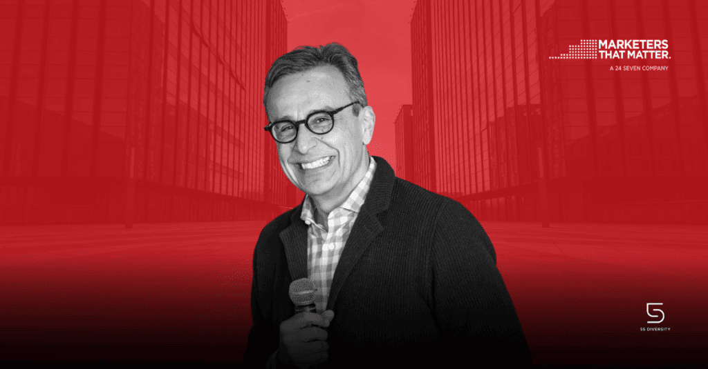 The Realities of Purpose Every Marketer Should Know by Antonio Lucio. Hispanic man holding microphone in black and white, up against a red background.
