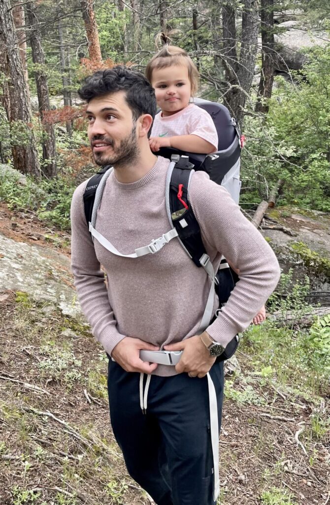 Man hiking with daughter on back